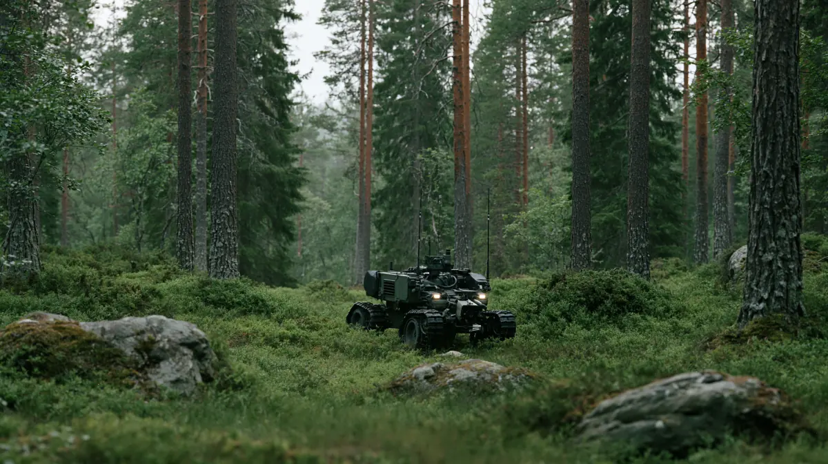 An uncrewed ground vehicle on patrol in a misty Nordic pine forest